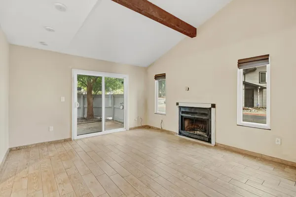 a view of empty room with a fireplace
