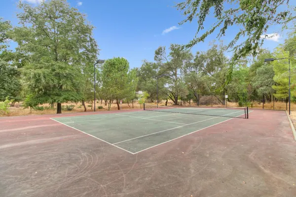 a view of a playground with basketball court