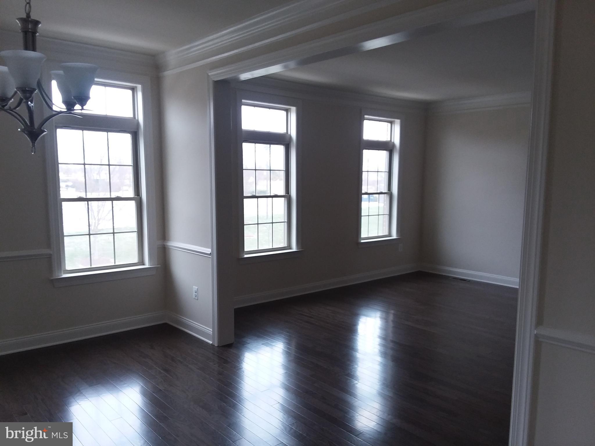 22595 Windsor Locks Square Ashburn, VA 20148 - Photo 18 of 56 an empty room with wooden floor and windows