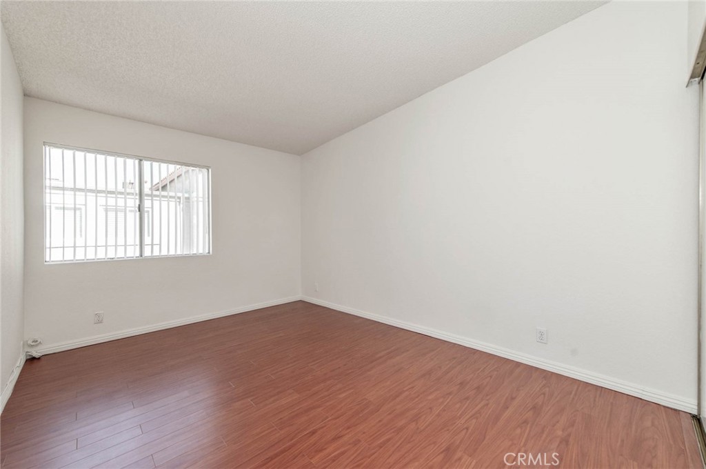 24320 Sylvan Glen Road, Unit E Diamond Bar, CA 91765 - Photo 12 of 20 an empty room with wooden floor and windows
