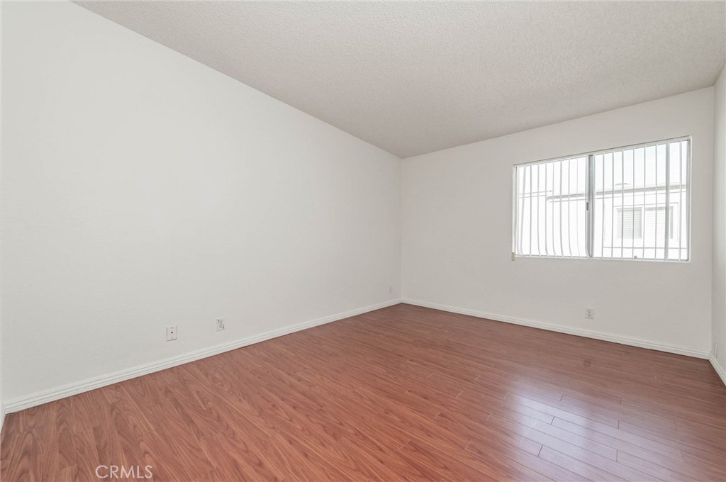24320 Sylvan Glen Road, Unit E Diamond Bar, CA 91765 - Photo 14 of 20 an empty room with wooden floor and windows