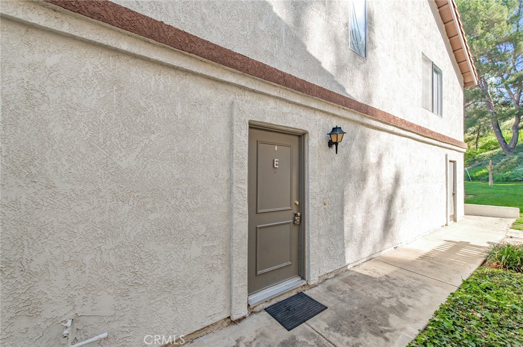 24320 Sylvan Glen Road, Unit E Diamond Bar, CA 91765 - Photo 3 of 20 a view of a front door and wooden bench