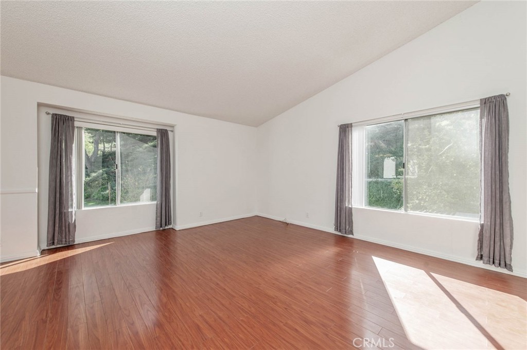 24320 Sylvan Glen Road, Unit E Diamond Bar, CA 91765 - Photo 5 of 20 a view of an empty room with wooden floor and a window