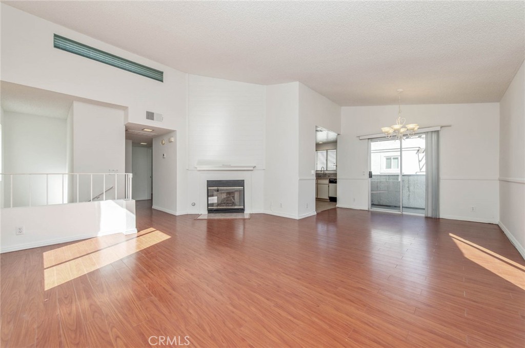 24320 Sylvan Glen Road, Unit E Diamond Bar, CA 91765 - Photo 6 of 20 a view of empty room with wooden floor and fireplace
