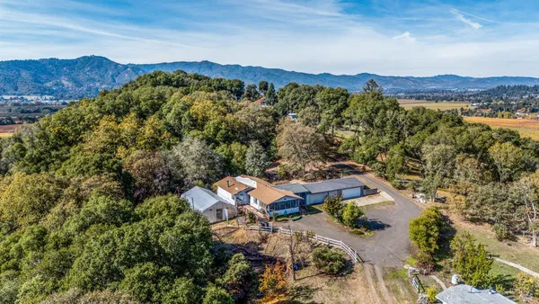 an aerial view of a house with mountain view