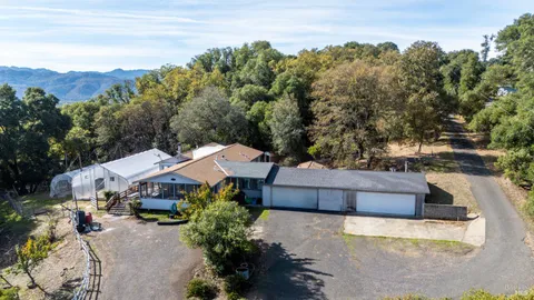 a terrace with outdoor seating and trees