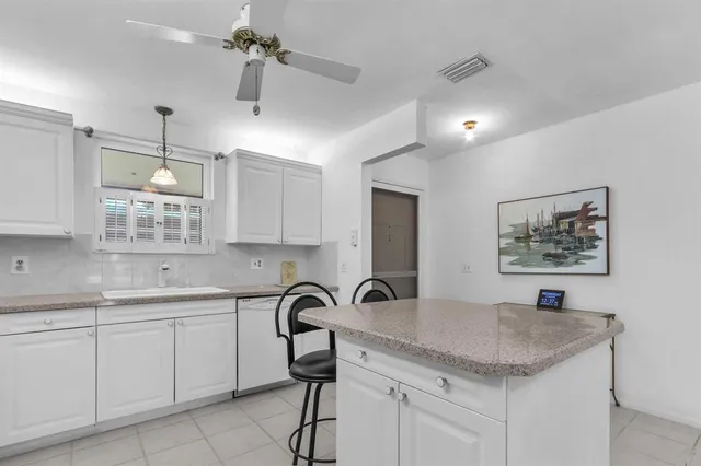 a kitchen with a sink cabinets and wooden floor