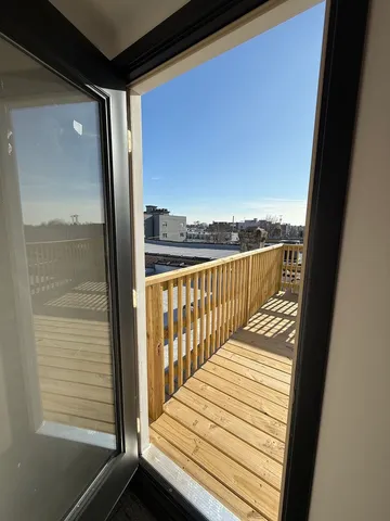 a view of balcony with wooden floor