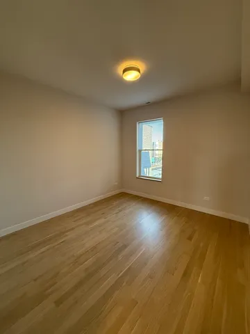 a view of an empty room and wooden floor