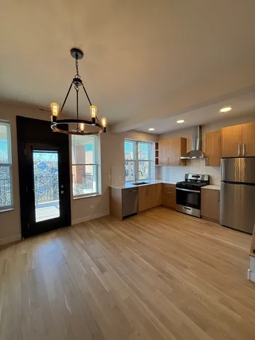 a view of a kitchen with a dishwasher cabinets and a wooden floor