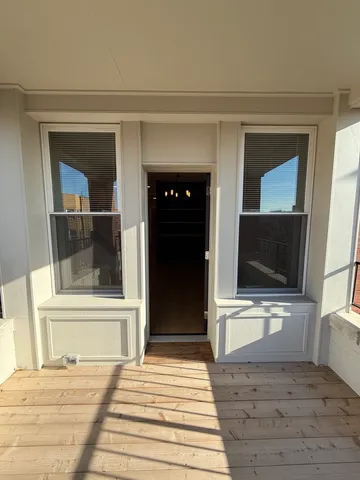 a view of a livingroom with wooden floor and furniture