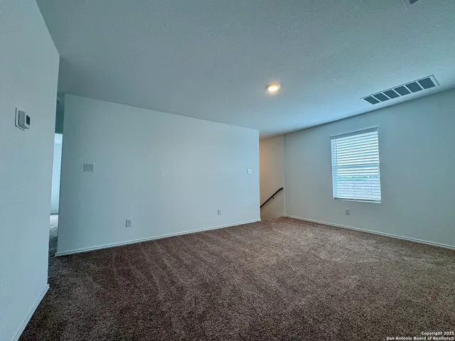 an empty room with a empty space and windows