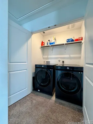 a utility room with a sink and cabinets