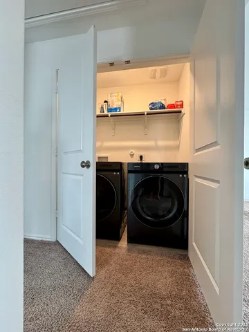 a view of a room with washer and dryer