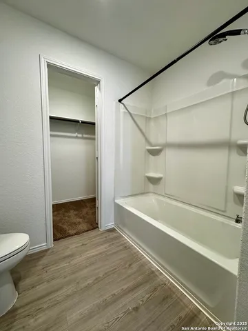 a bathroom with a double vanity sink and a toilet