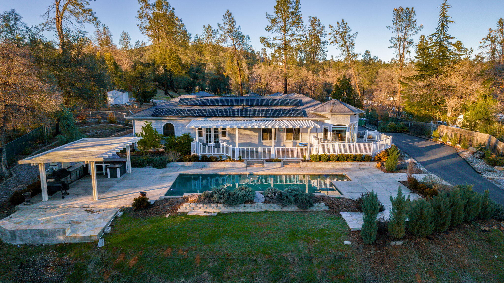a view of a house with garden and a patio
