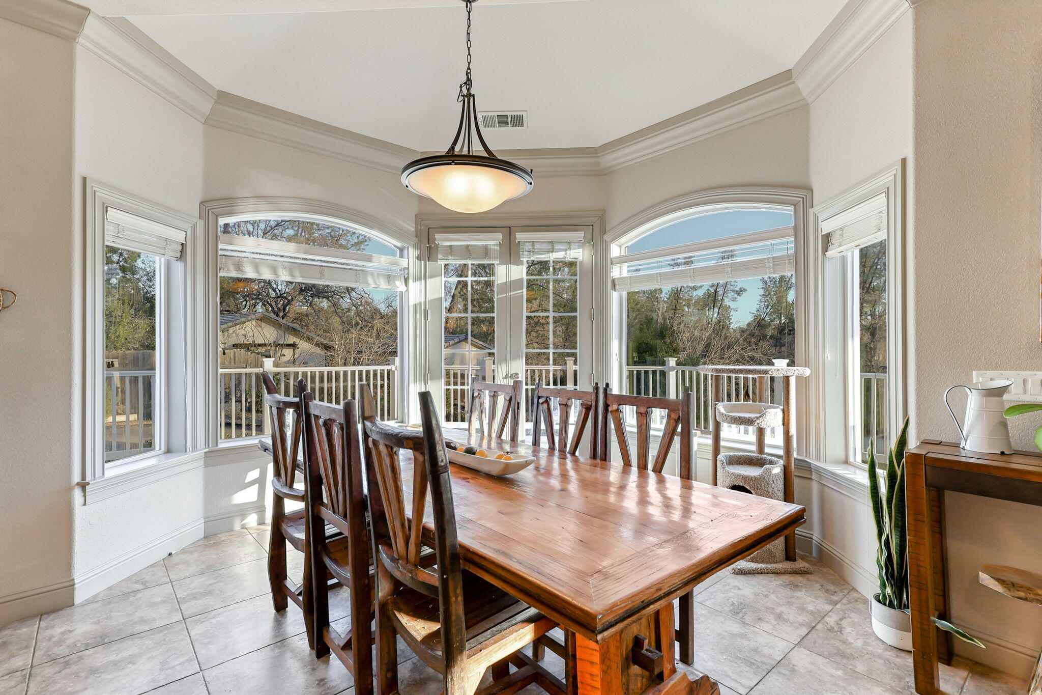 9271 Placer Road Redding, CA 96001 - Photo 10 of 45 a dining room with furniture large windows and a chandelier