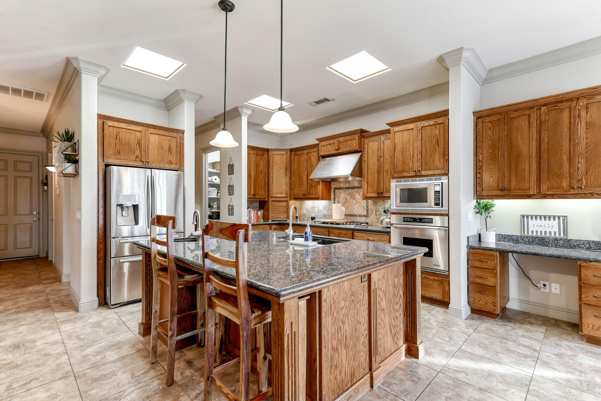 9271 Placer Road Redding, CA 96001 - Photo 11 of 45 a kitchen with stainless steel appliances granite countertop a stove top oven a sink island and a refrigerator