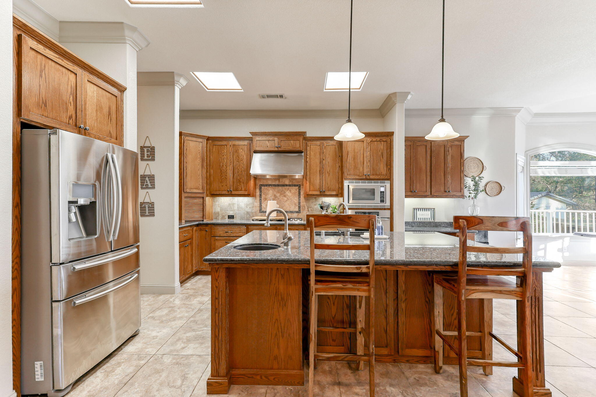 9271 Placer Road Redding, CA 96001 - Photo 12 of 45 a kitchen with granite countertop a sink cabinets and stainless steel appliances