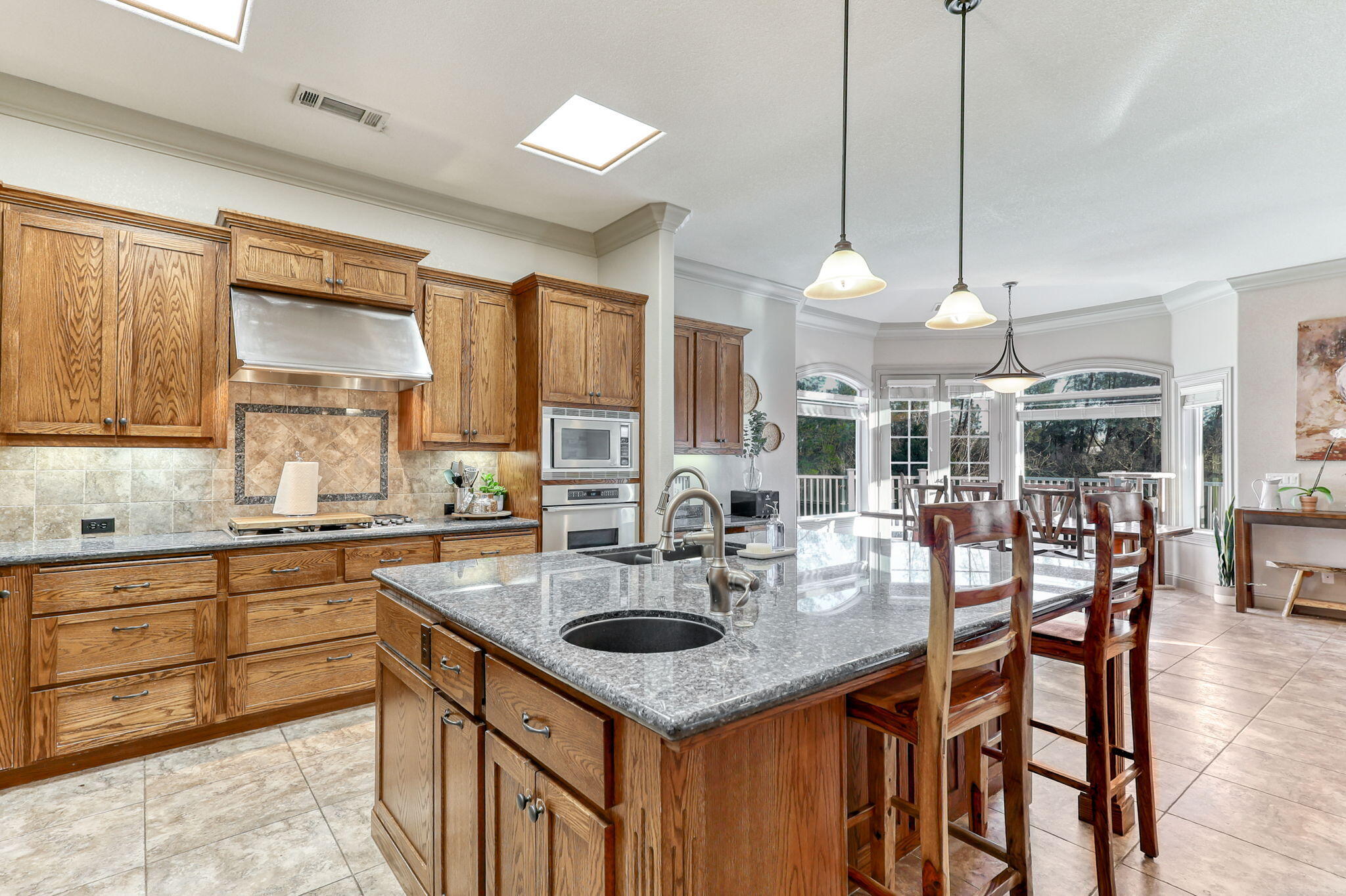 9271 Placer Road Redding, CA 96001 - Photo 13 of 45 a kitchen with granite countertop a sink a counter space appliances and cabinets