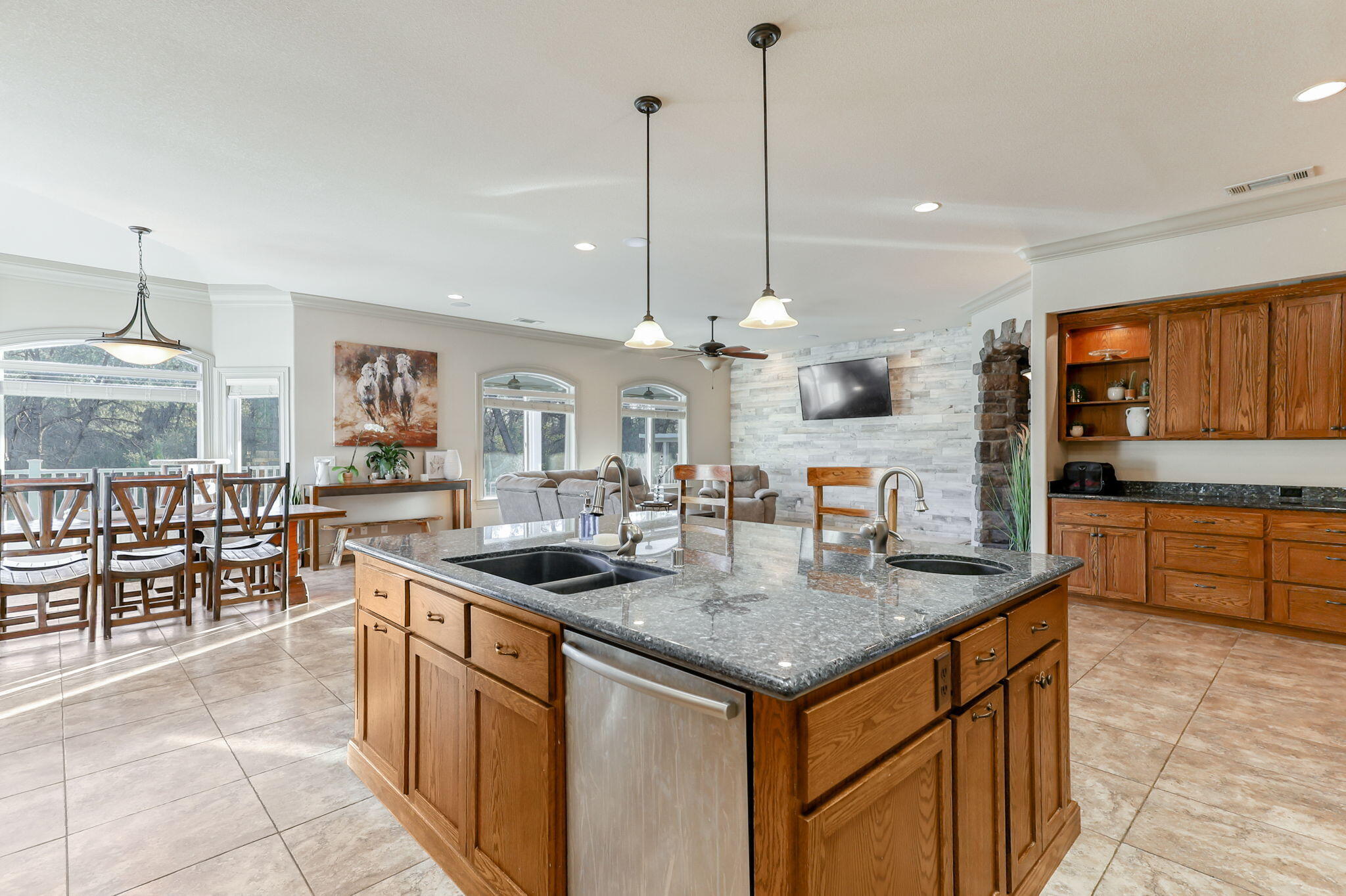 9271 Placer Road Redding, CA 96001 - Photo 14 of 45 a kitchen with stainless steel appliances granite countertop a stove a sink a oven a dining table and chairs