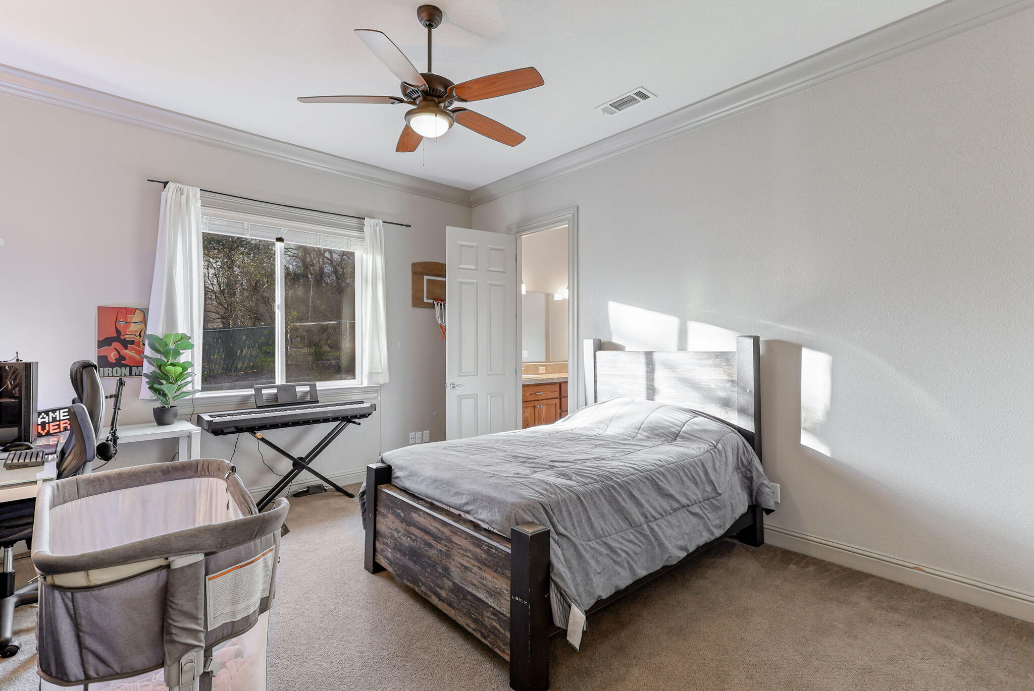 9271 Placer Road Redding, CA 96001 - Photo 20 of 45 a bedroom with a bed next to a window with chair and table