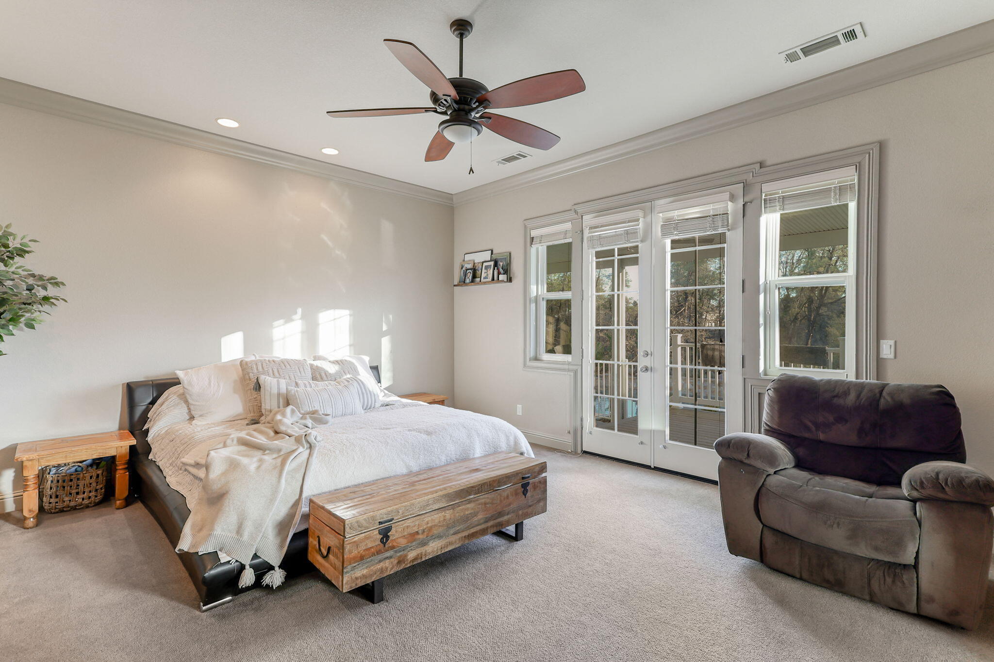 9271 Placer Road Redding, CA 96001 - Photo 25 of 45 a spacious bedroom with a bed couch and a large window