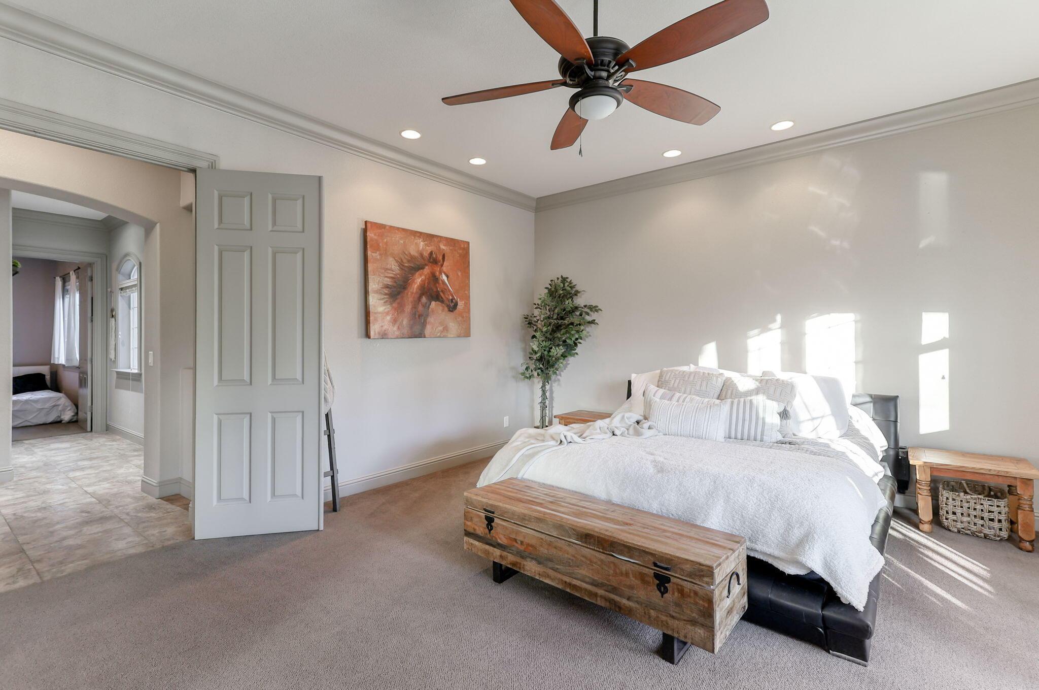 9271 Placer Road Redding, CA 96001 - Photo 27 of 45 a spacious bedroom with a bed and a chandelier