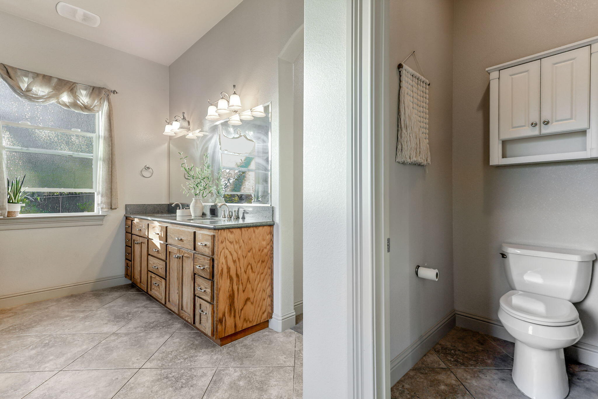 9271 Placer Road Redding, CA 96001 - Photo 28 of 45 a bathroom with a toilet sink and mirror