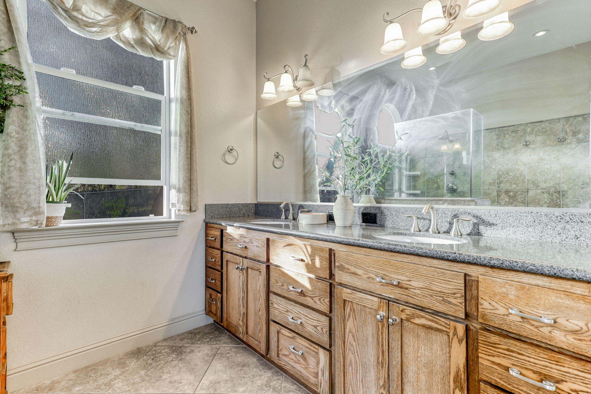 9271 Placer Road Redding, CA 96001 - Photo 30 of 45 a bathroom with a double vanity sink and a mirror