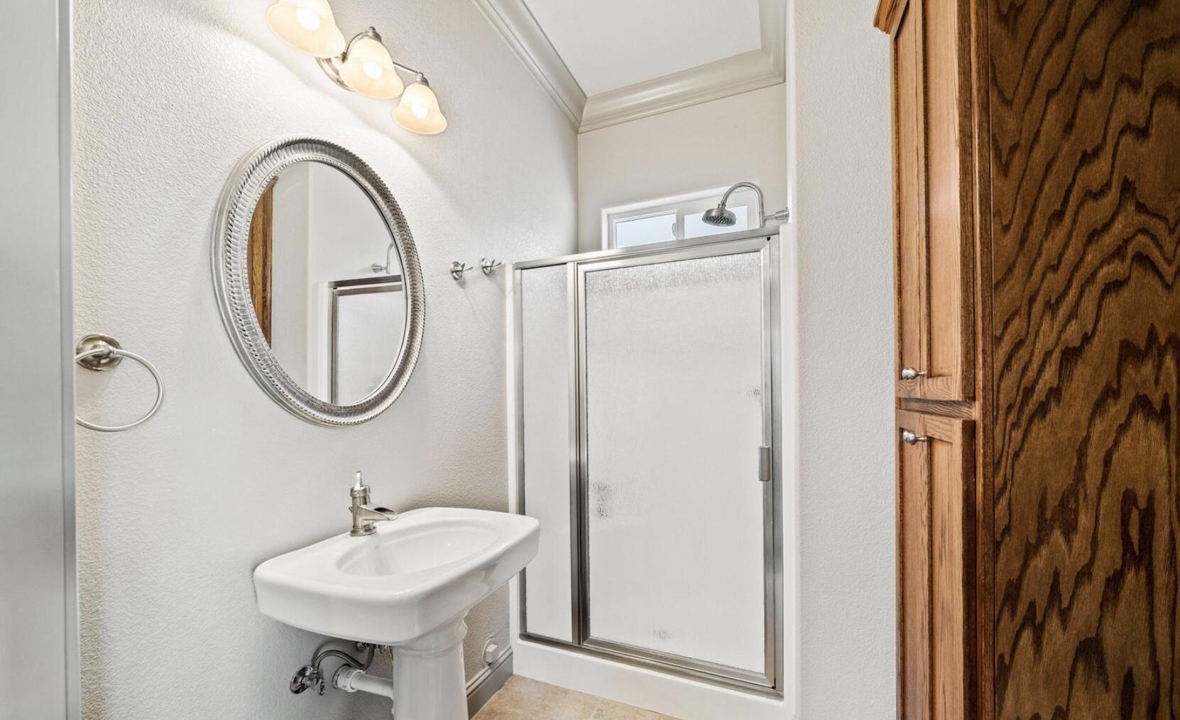 9271 Placer Road Redding, CA 96001 - Photo 34 of 45 a bathroom with a sink a mirror and a shower curtain