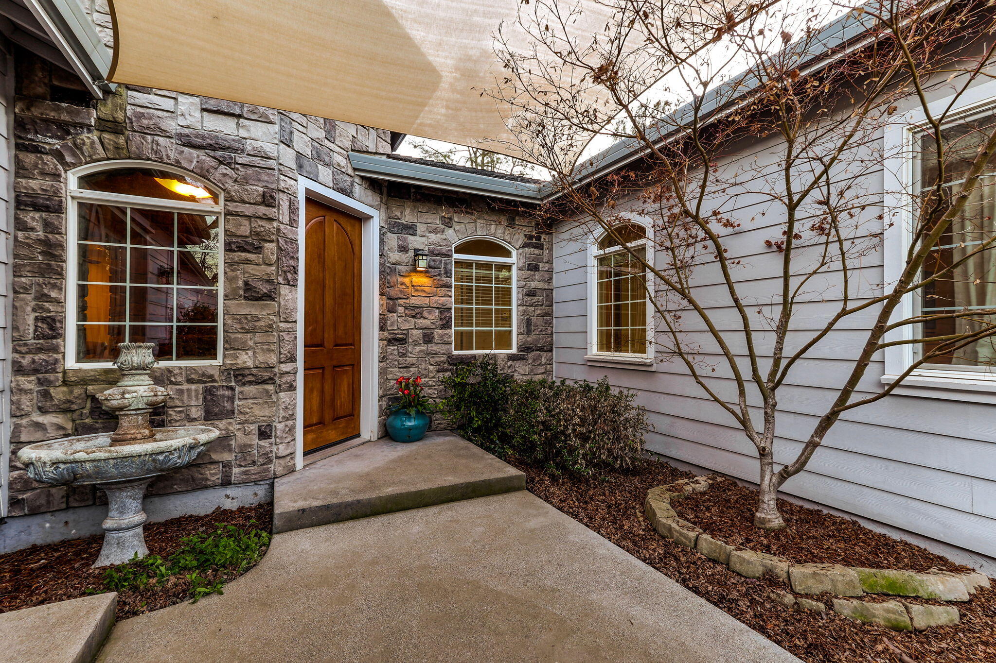 9271 Placer Road Redding, CA 96001 - Photo 5 of 45 a front view of a house with garden