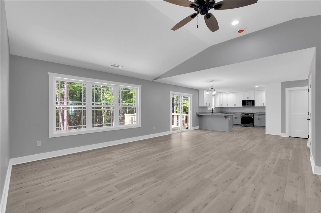 An open-concept living area with abundant natural light flows seamlessly into a contemporary kitchen.
