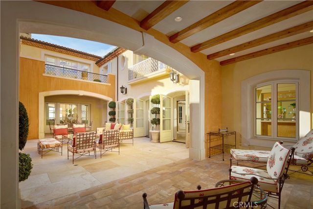 a bedroom with a bed and a large mirror with a large window