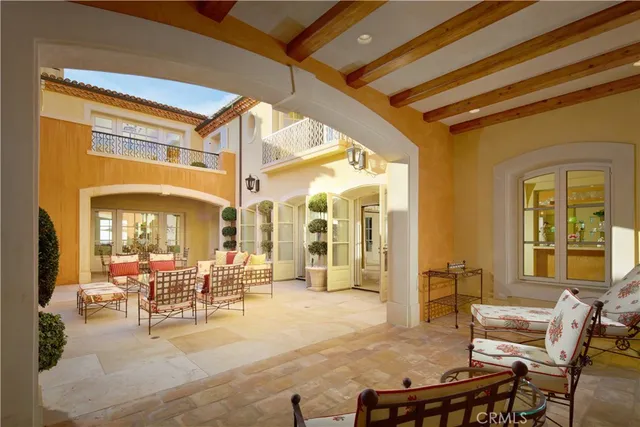 a bedroom with a bed and a large mirror with a large window