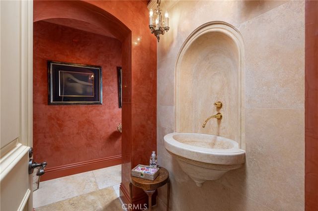 a bathroom with a sink a toilet a mirror and shower