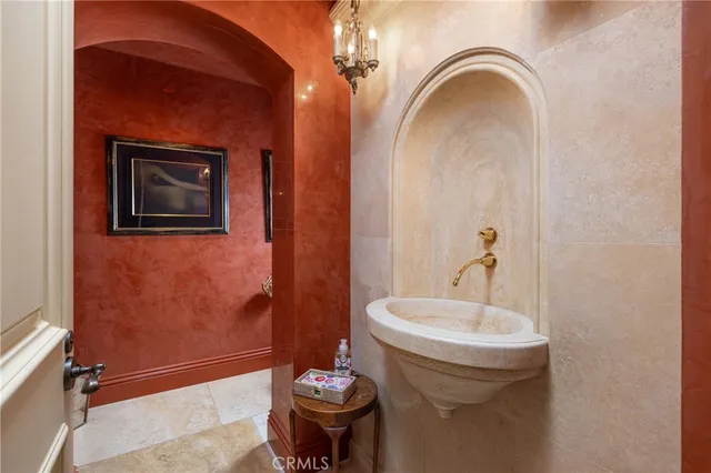 a bathroom with a sink a toilet a mirror and shower