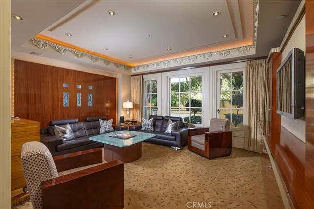 a living room with furniture and a chandelier