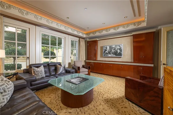 a bedroom with a bed and large windows