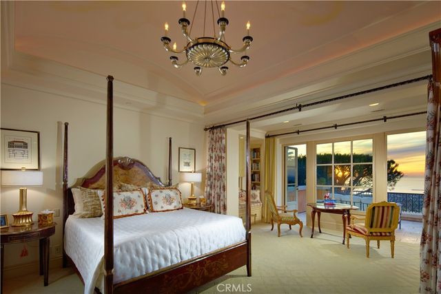 a front view of a house with a garden and trees