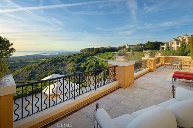 a view of a park with potted plants and a large tree