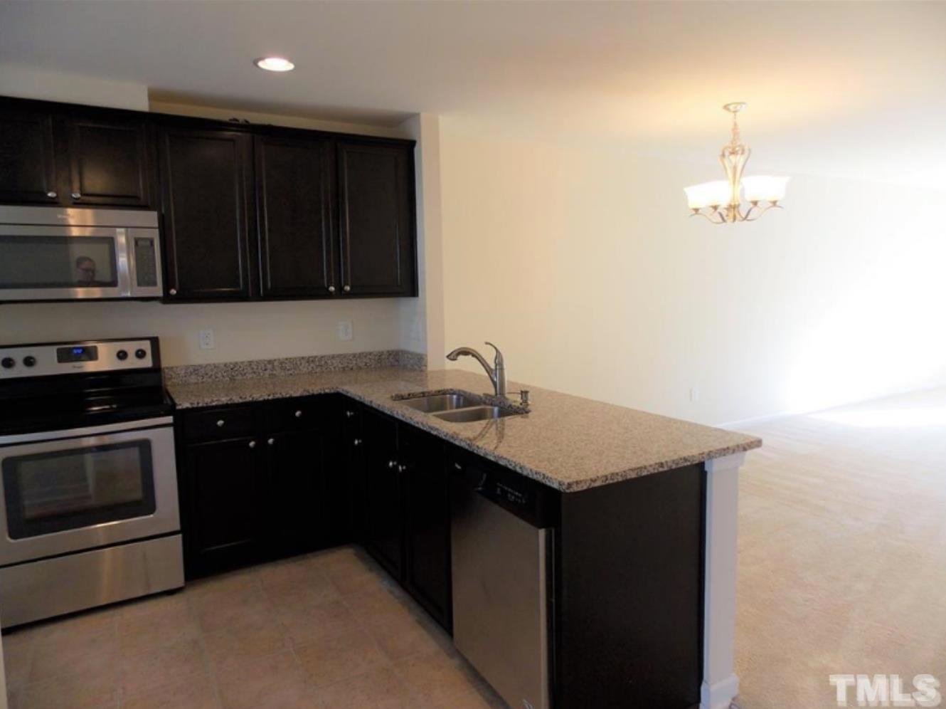 3910 Swinton Street Raleigh, NC 27616 - Photo 3 of 6 a kitchen with a sink and a stove top oven
