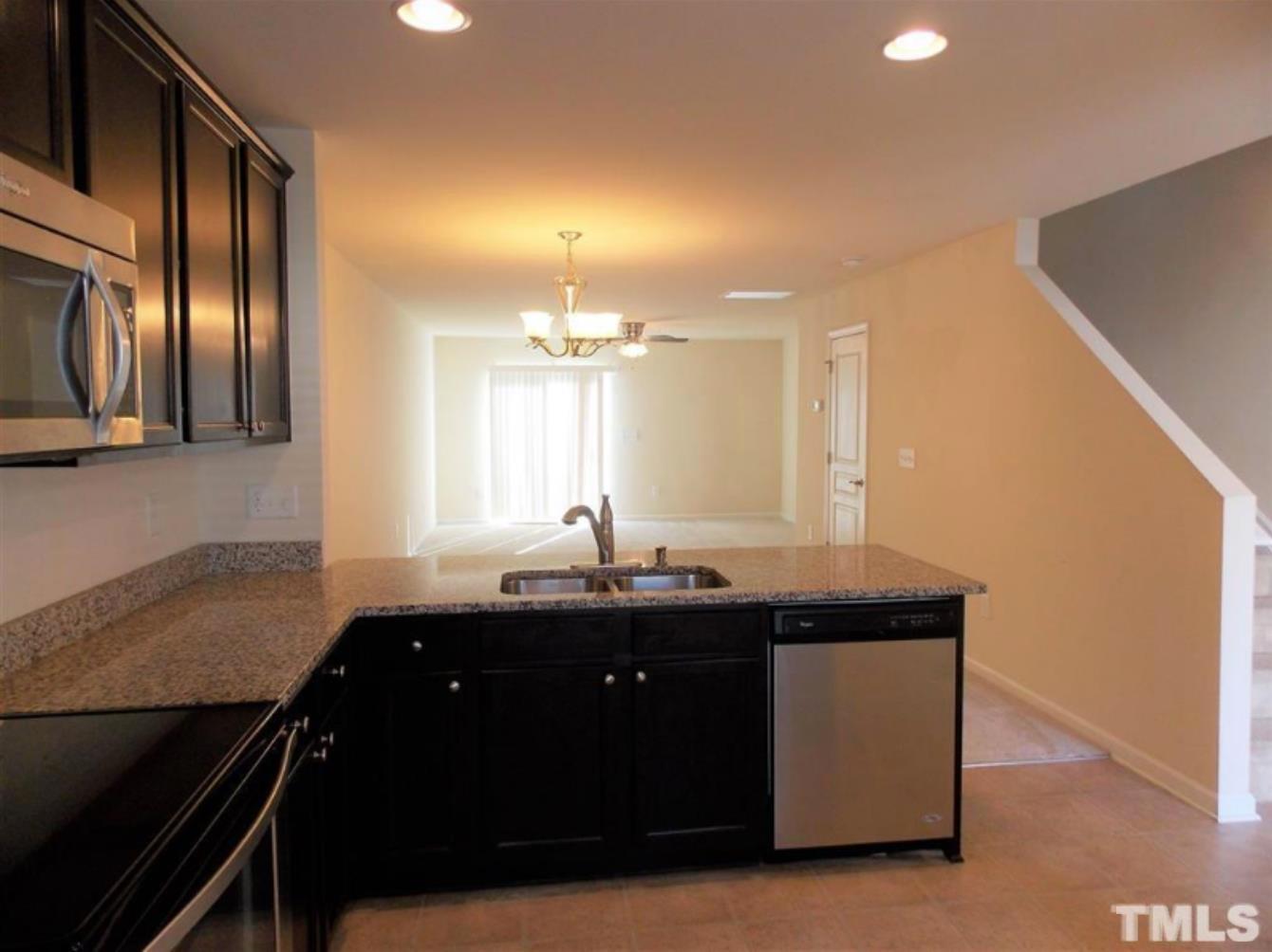 3910 Swinton Street Raleigh, NC 27616 - Photo 5 of 6 a kitchen with granite countertop a sink and cabinets