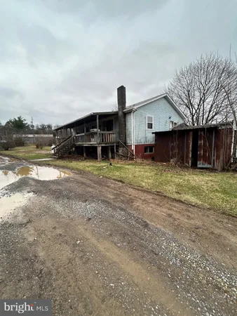 a view of a house with yard and sitting area