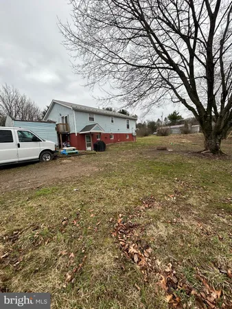a view of yard with car parked