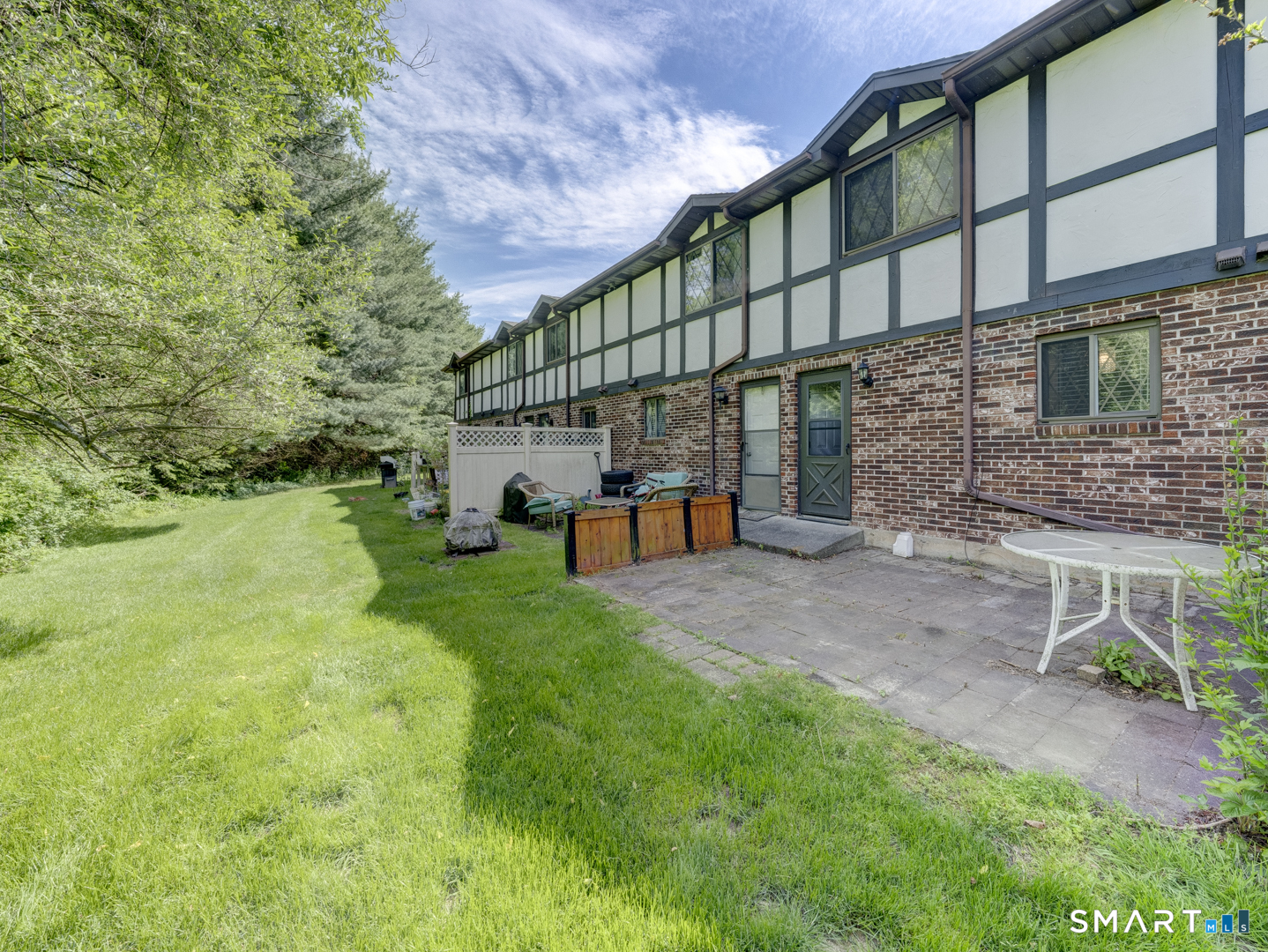 2 Branch Road, Unit 2C Thomaston, CT 06787 - Photo 22 of 26 a backyard of a house with a yard and outdoor seating