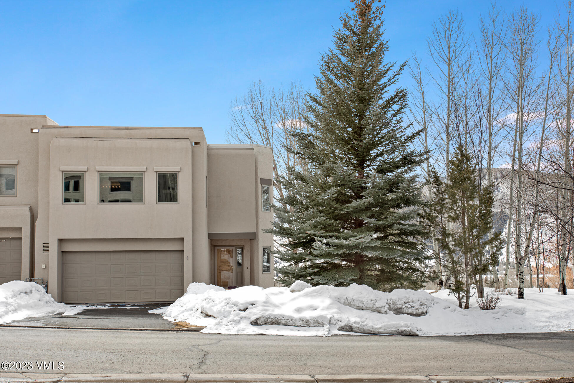 a view of a house with snow on the road