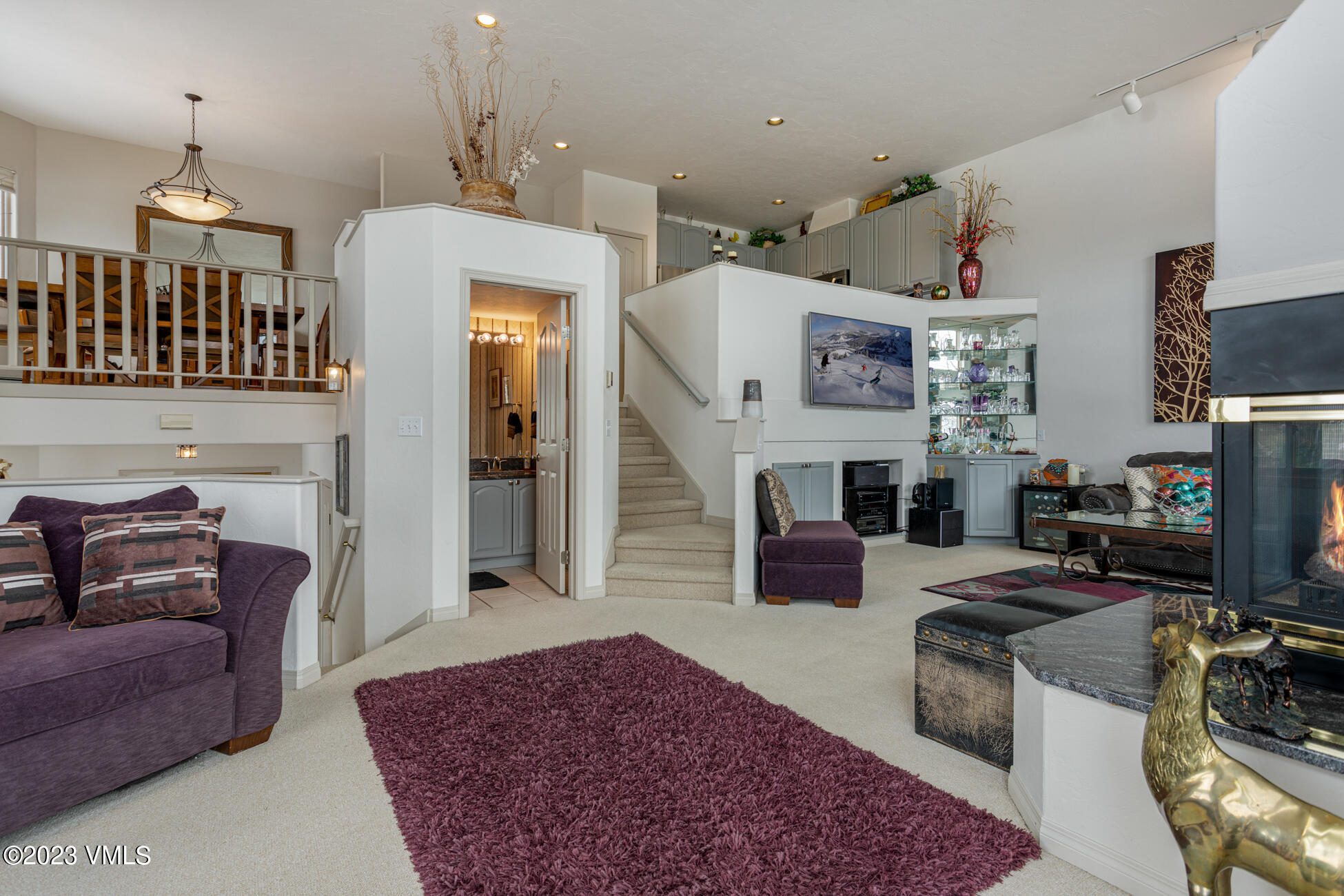 751 Singletree Road, Unit 1 Edwards, CO 81632 - Photo 4 of 16 a living room with furniture a fireplace and a chandelier
