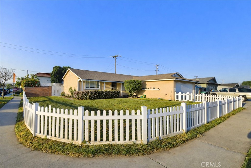 7251 Middlesex Drive Stanton, CA 90680 - Photo 2 of 11 a front view of a house with wooden fence