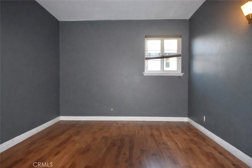 7251 Middlesex Drive Stanton, CA 90680 - Photo 7 of 11 an empty room with wooden floor and windows